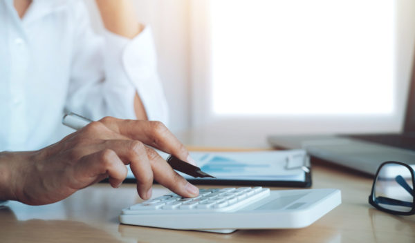 Finances Saveing Economy concept. Female accountant or banker us Finances Saveing Economy concept. Female accountant or banker use calculator.